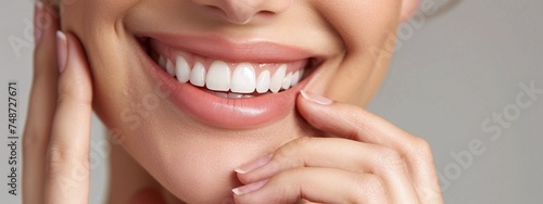 beautiful teeth of caucasian woman closeup with hand on chin showcasing bright smile and dental health care photo