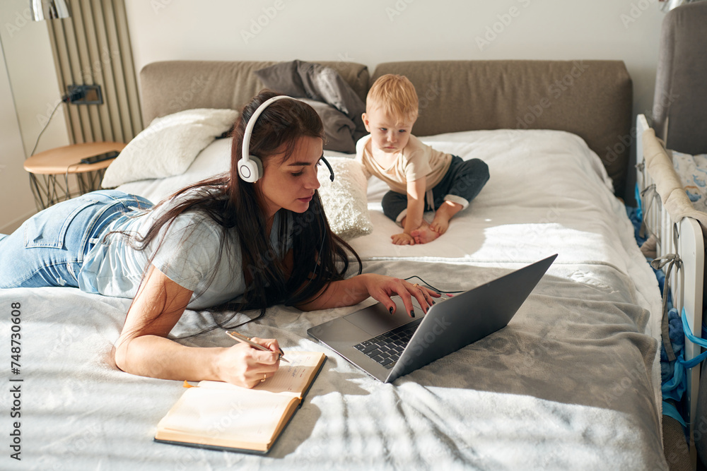 Mother with her little son is at home in domestic room Mother with her little son is at home in domestic room
