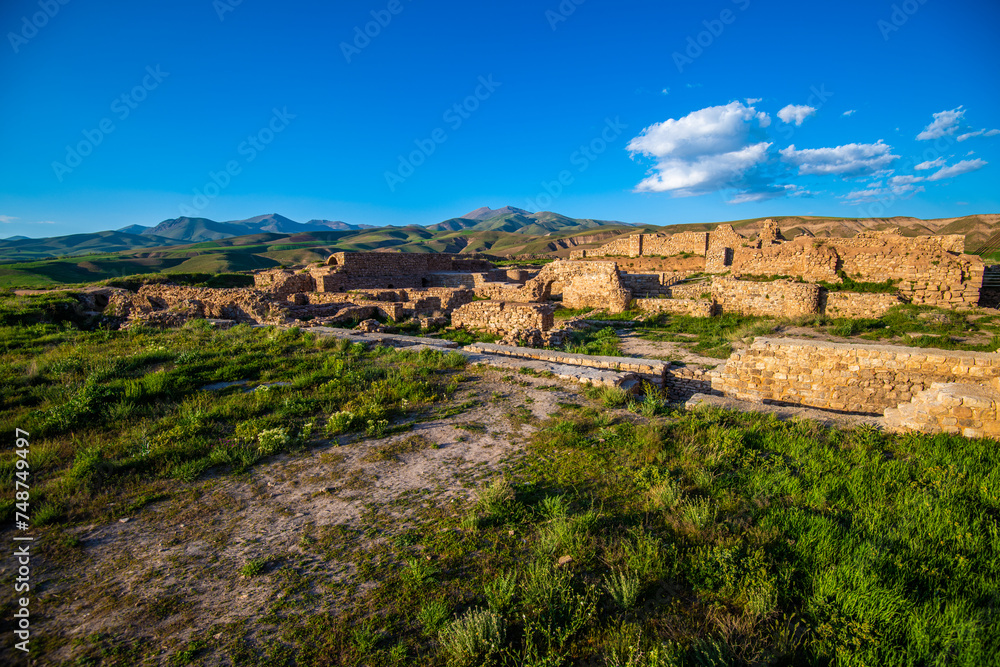 Sunlit Remnants of the Takht-e Soleyman Fortress Amidst Rolling Hills in West Azerbaijan Province, Iran