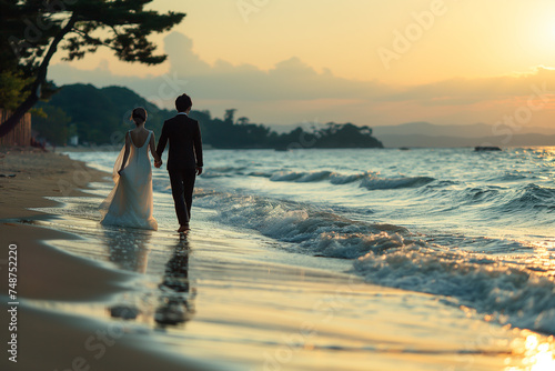 Newlyweds walking on the beach in summer, barefoot