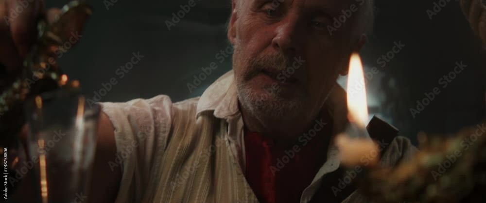 An old pirate captain eats and drinks inside vintage ship cabin An old pirate captain eats and drinks inside vintage ship cabin