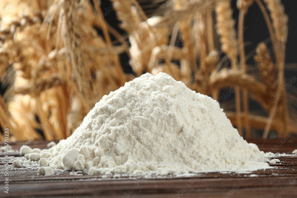 Pile of flour at wheat ears background