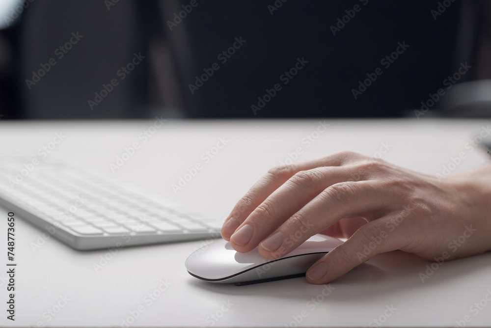 A man works at a computer. Computer mouse close-up. A man works at a computer. Computer mouse close-up.