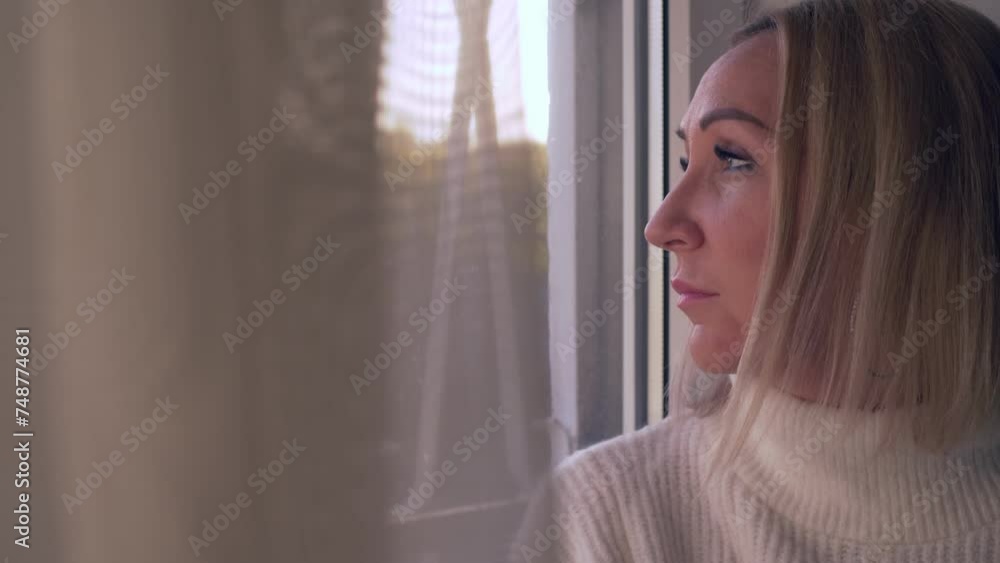 lonely woman looks out the window - sadness, depression, thoughts lonely woman looks out the window - sadness, depression, thoughts