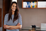 Portrait, smile and arms crossed with woman in design office of small business or startup company. Creative, designer and happy young employee looking confident in agency or professional workplace