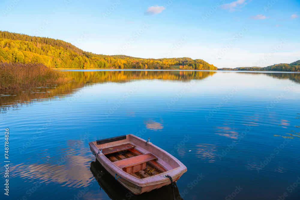 boat on the lake with autumn colors boat on the lake with autumn colors