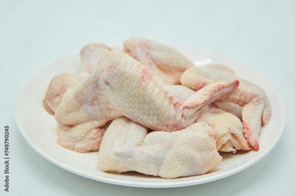 Raw meat chicken wings on a white background. Different parts of meat products for different dishes.