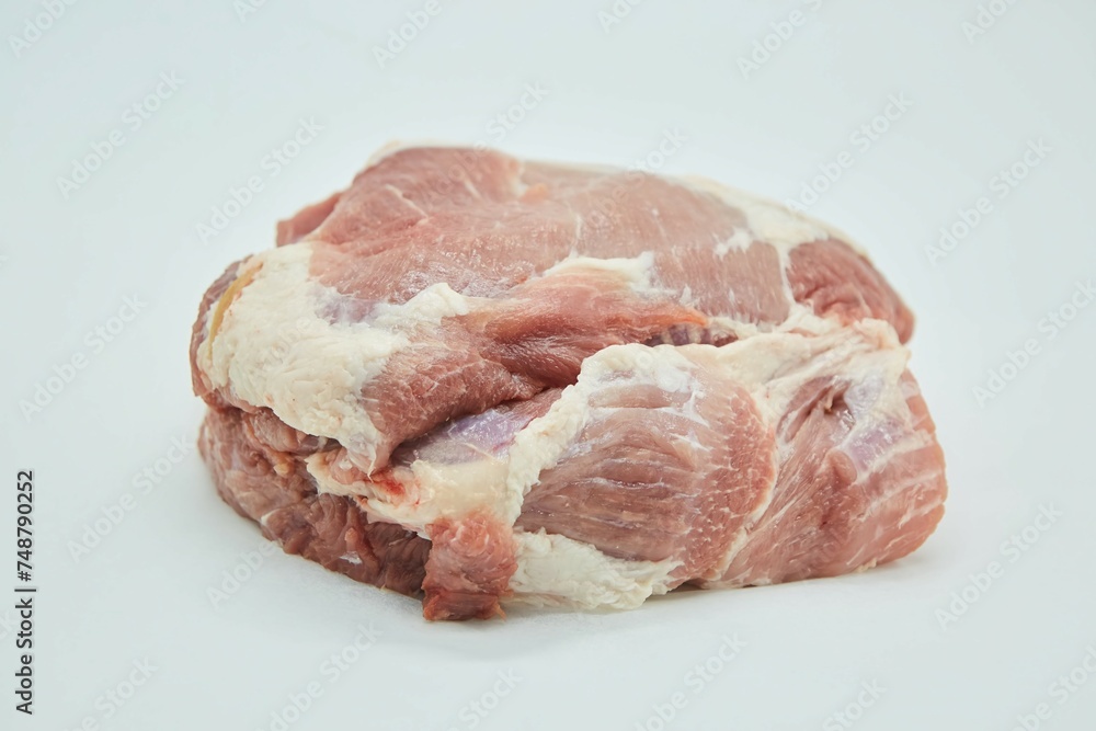 Raw meat on a white background. Pork, beef or lamb. Steak or tenderloin. Different parts of meat products for different dishes. Raw meat on a white background. Pork, beef or lamb. Steak or tenderloin. Different parts of meat products for different dishes.