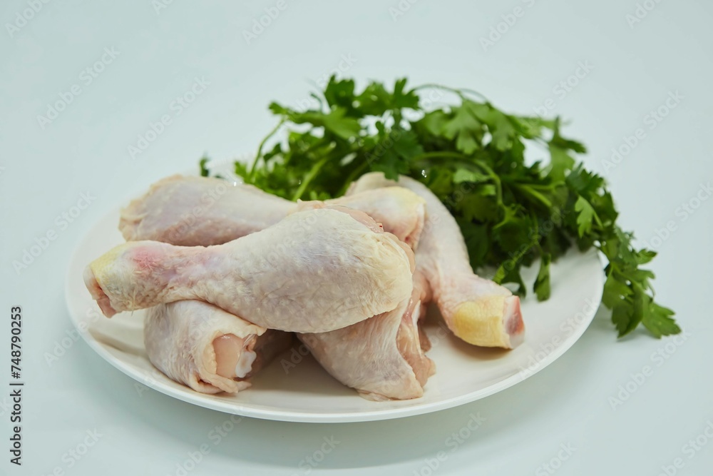 Raw meat chicken legs on a white background. Different parts of meat products for different dishes. Raw meat chicken legs on a white background. Different parts of meat products for different dishes.