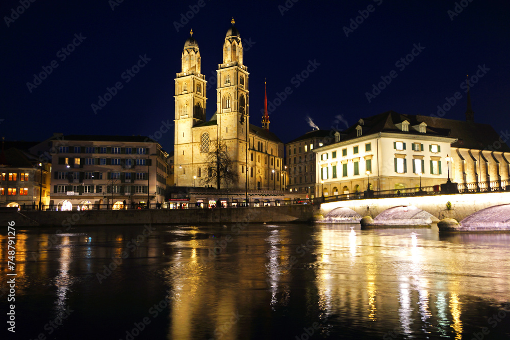 View of Grossmunster and Zurich old town from Limmat river. The Grossmunster is a Romanesque-style Protestant church in Zurich, Switzerland.