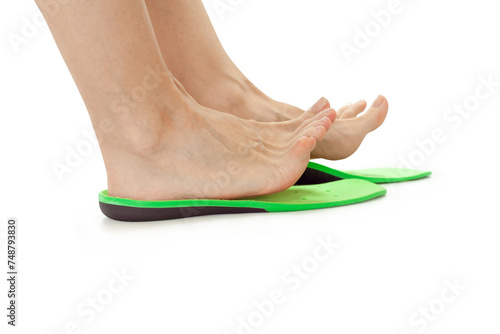 female feet stand in orthopedic insoles