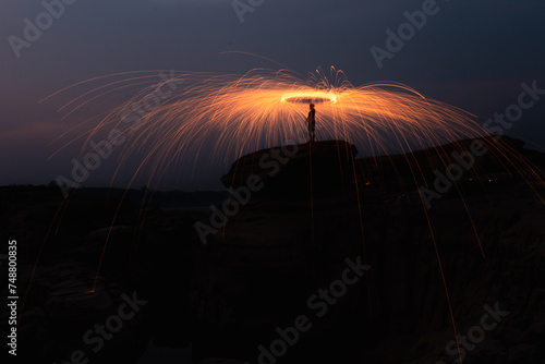 Abstract background of steel wool fireworks on Hat Chom Dao Na Tan, Na Tan District, Ubon Ratchathani, Thailand, Showers of glowing sparks from spinning steel wool,	