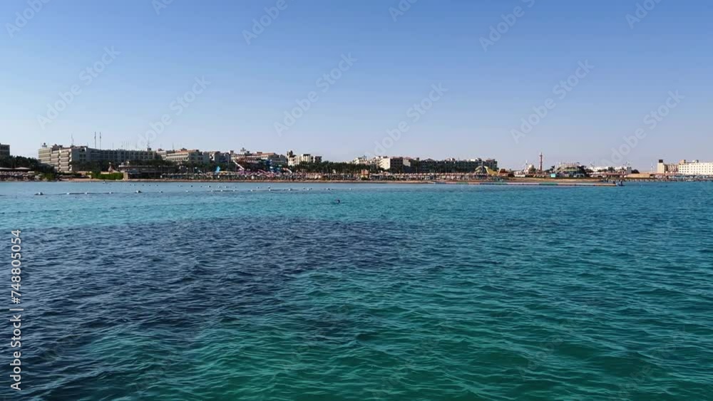 Blue water with sun glare and swimming fish. Top view of fish swimming in the water over a rocky bottom in the Red Sea in Egypt. The seaside resort is all inclusive and travel. Hurghada 2022 Blue water with sun glare and swimming fish. Top view of fish swimming in the water over a rocky bottom in the Red Sea in Egypt. The seaside resort is all inclusive and travel. Hurghada 2022