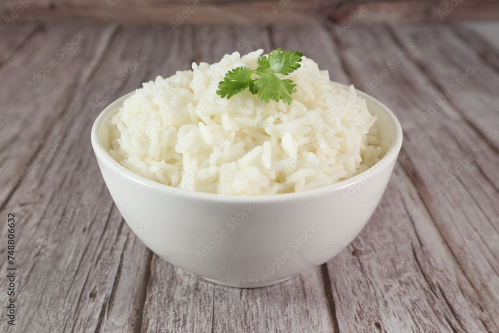 White rice in bowl on wood table White rice in bowl on wood table