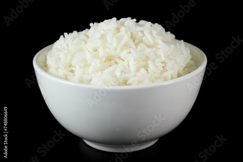 White rice in bowl on wood table.