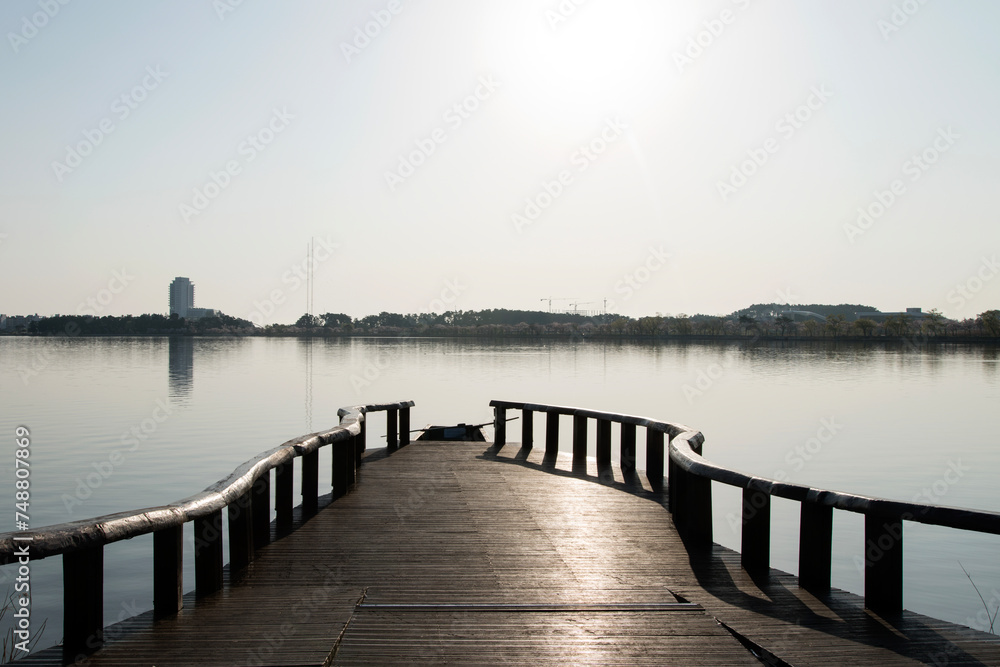 View of the wooden dock at the lakeside in the morning