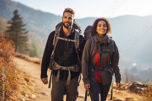 Young couple with backpacks hiking in a mountainous landscape