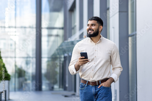 Young professional using a smartphone in a modern urban setting