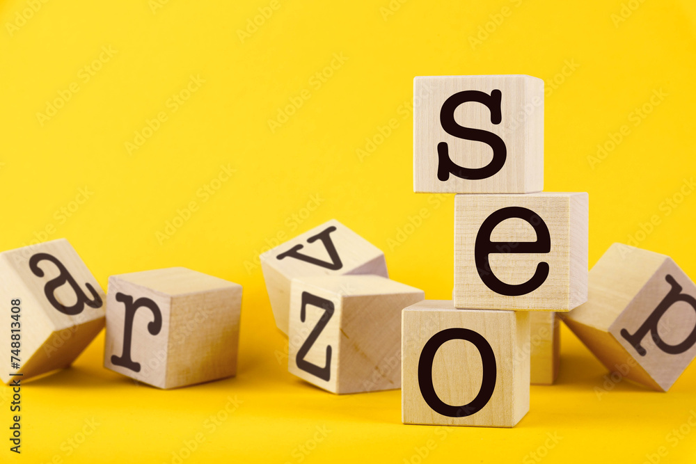 SEO, search engine optimization, text wooden cube blocks on yellow background. Idea, vision, strategy, analysis, keyword and content concept SEO, search engine optimization, text wooden cube blocks on yellow background. Idea, vision, strategy, analysis, keyword and content concept