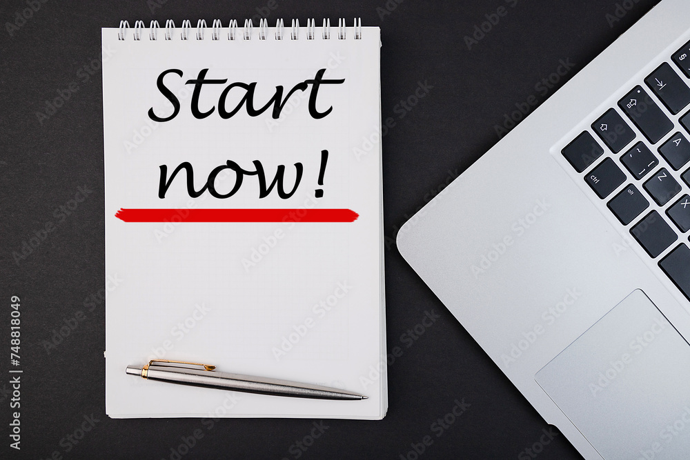 Start now notepad writing concept on dark background with pen. Start now notepad writing concept on dark background with pen.