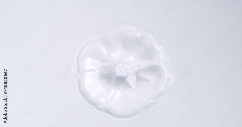 Super slow motion macro of dripping single drop of fresh organic bio milk is falling into liquid white milk splashing and making ripples filmed at 1000 fps. Super slow motion macro of dripping single drop of fresh organic bio milk is falling into liquid white milk splashing and making ripples filmed at 1000 fps.