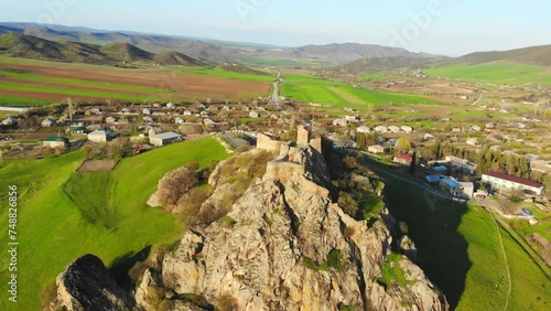 Aerial panning view Kveshi fortress with georgian countryside panorama. Historical and cultural heritage n Georgia photo