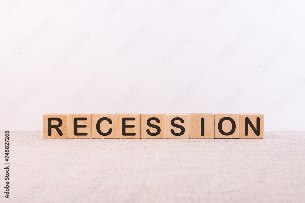 Word RECESSION is made of wooden building blocks lying on a light background. Word RECESSION is made of wooden building blocks lying on a light background.
