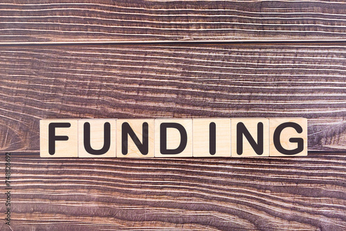 FUNDING word made with wood building blocks.