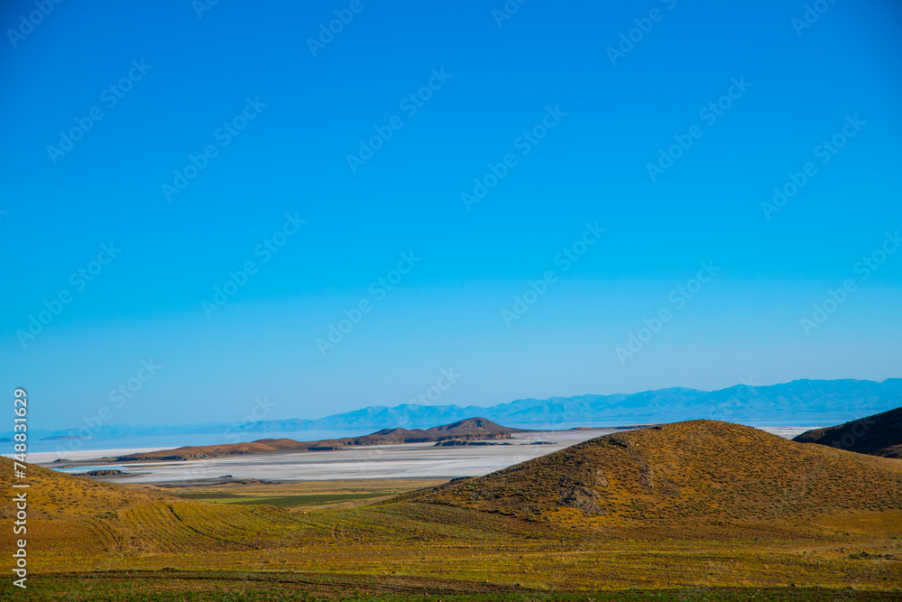 Harmony of Earth and Sky: The Undulating Hills of Lake Urmia, West Azerbaijan, Iran Harmony of Earth and Sky: The Undulating Hills of Lake Urmia, West Azerbaijan, Iran