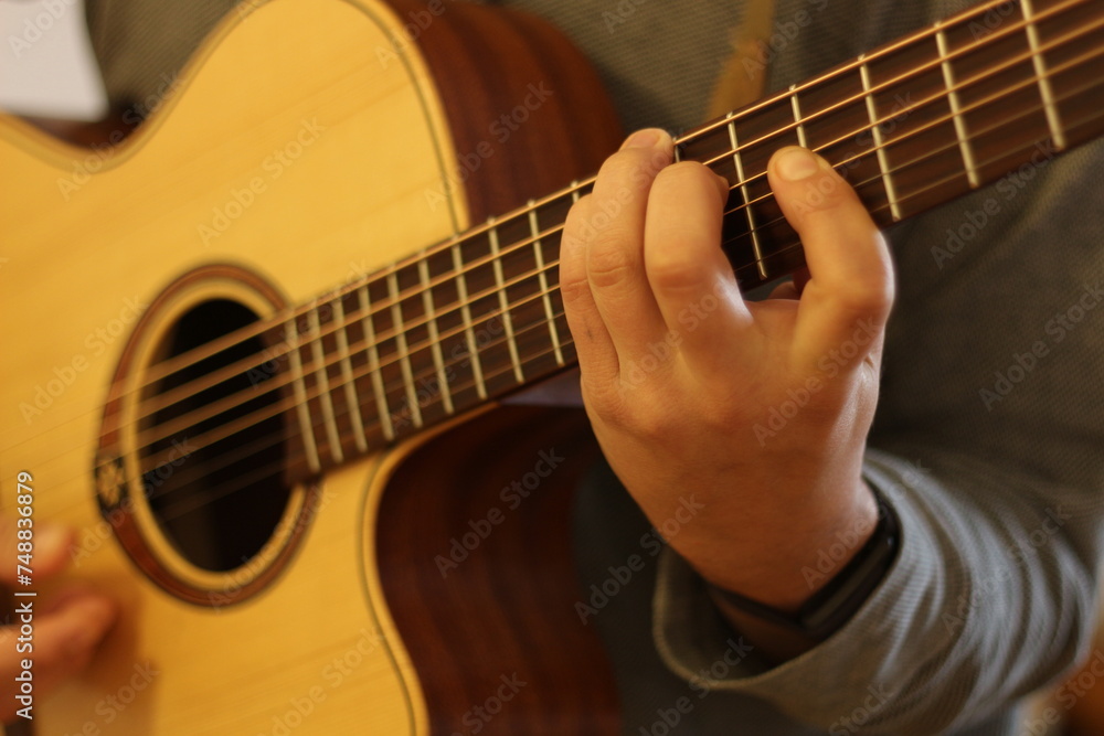 Fototapeta premium Harmonic Finesse: Hands Crafting Chords