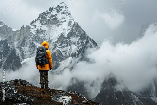 Mountaineer overlooking a foggy mountain range.