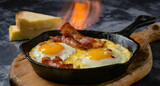 frying pan with meat .  food contest winner photo, hot fried eggs on a molten iron skillet with bacon pieces and mol.