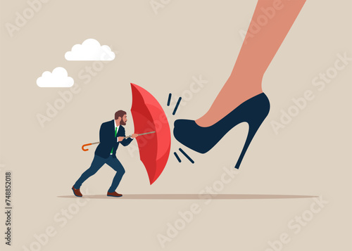 Male holding an open red umbrella which protects from a collision with a legs boss. Demoralised employee. stress with boss's.