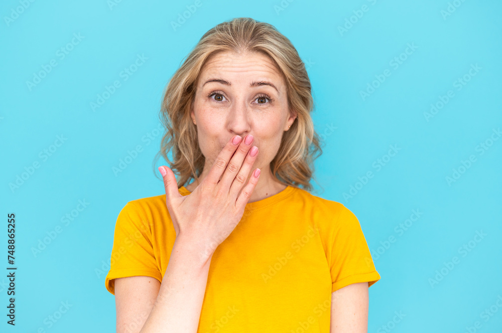Shy smiling woman covering her mouth with hand