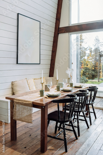 Setting table in dining room, chairs, plates, wine glass and candles