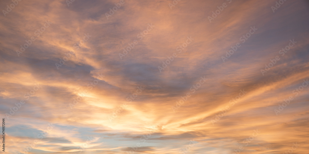 shiny sky background at sunset with yellow and grey clouds