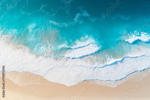 Mesmerizing drone shot sandy shore meets vast, tranquil blue ocean