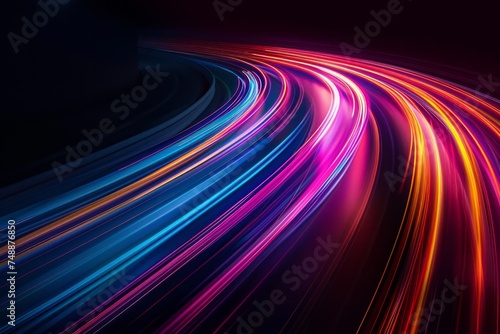 Abstract image of colorful light streaks in motion on a dark background.