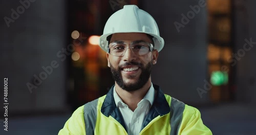 Face, architecture or happy man in city with confidence or smile for engineering labor or building. Construction site, safety and portrait of a proud builder, worker and contractor in night project photo