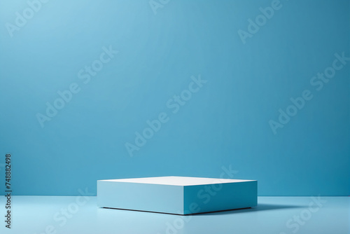Empty pedestal display on blue background with blank stand for product show or presentation