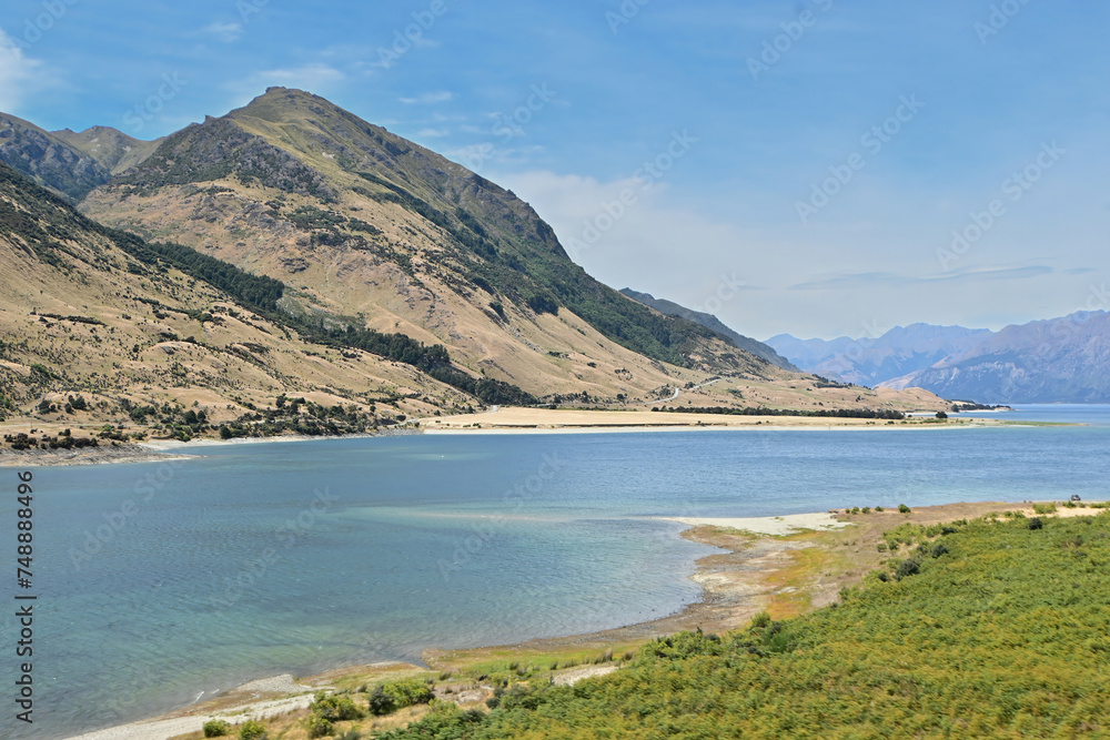 A beautiful view of tranquil landscape along the route near Lake Wānaka in summer season, New Zealand.