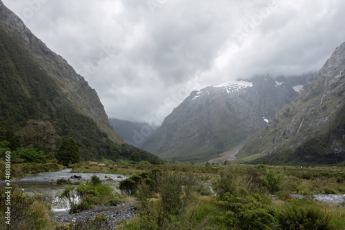 A journey in Valley of a Thousand Waterfalls in a foggy day, Milford Sound, New Zealand