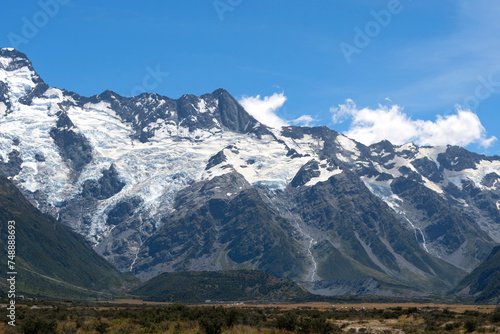 The massive mountains with glacier in a peaceful summer day with fresh blue sky at Mount Cook National Park  New Zealand.