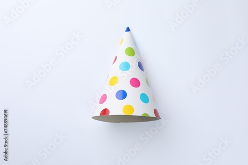 One beautiful party hat on light background, top view