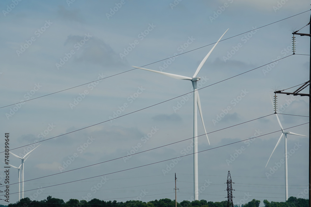 Wind turbines transfer renewable source of energy on power transmission lines. Production of alternative form of energy to prevent air pollution