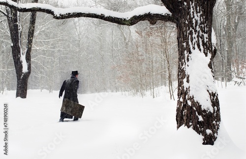 retro. man with suitcase walking in snow forest