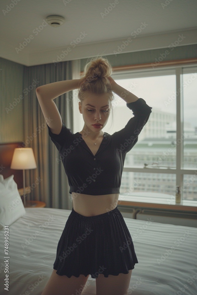Chic Scandic Style: Blonde Woman Strikes Elegant Pose in Hotel Room with Hands Raised Chic Scandic Style: Blonde Woman Strikes Elegant Pose in Hotel Room with Hands Raised