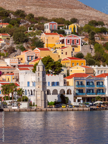 Multi-colored facades of houses in the Greek village Symi on a sunny day