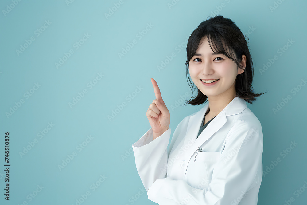 Smiling asian woman doctor showing a finger to the camera Smiling asian woman doctor showing a finger to the camera