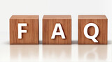 FAQ, representing Frequently Asked Questions, wooden blocks on the reflective floor